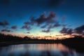 Beautiful sunset over the lake near the golf course in a tropical resort, Punta Cana Royalty Free Stock Photo