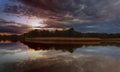 Beautiful sunset over lake with reflection in water, majestic clouds in the sky Toned Image Royalty Free Stock Photo