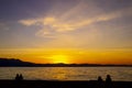 Beautiful sunset over Lake Tahoe CA USA with sihlouttes of two couples on beach watching Royalty Free Stock Photo