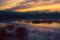 Beautiful sunset over lake in the winter.Mountains in background. Royalty Free Stock Photo