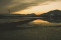 Beautiful sunset over lake in the winter.Mountains in background. Royalty Free Stock Photo