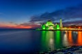 Beautiful sunset over the majestic mosque, Malacca Straits Mosque (Masjid Selat). Soft focus due to slow shutter shot. Royalty Free Stock Photo