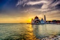 Beautiful sunset over the majestic mosque, Malacca Straits Mosque (Masjid Selat). Soft focus due to slow shutter shot. Royalty Free Stock Photo