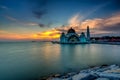 Beautiful sunset over the majestic mosque, Malacca Straits Mosque (Masjid Selat). Soft focus due to slow shutter shot. Royalty Free Stock Photo