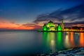 Beautiful sunset over the majestic mosque, Malacca Straits Mosque (Masjid Selat). Soft focus due to slow shutter shot. Royalty Free Stock Photo