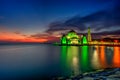 Beautiful sunset over the majestic mosque, Malacca Straits Mosque (Masjid Selat). Soft focus due to slow shutter shot. Royalty Free Stock Photo