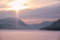 Beautiful sunset over the mountain lake Teletskoe in Altai in winter