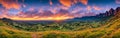 beautiful sunset over mountains and hills of pastures and farms in villages. Amazing colorful sky and incredible landscape to Royalty Free Stock Photo