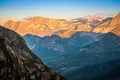 Beautiful sunset over the mountains, with the sun illuminating the high peaks and the valley remaining in shadow Royalty Free Stock Photo