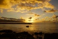 Beautiful Sunset over the ocean along rocky shore Royalty Free Stock Photo