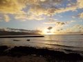 Beautiful Sunset over the ocean along rocky shore Royalty Free Stock Photo