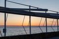 A beautiful sunset over the ocean with a metal railing in the background Royalty Free Stock Photo