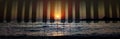 Beautiful sunset over ocean waves with transparent piano tiles overlay