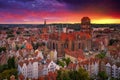 Beautiful sunset over the old town of Gdansk with City Hall and St. Mary Basilica, Poland Royalty Free Stock Photo