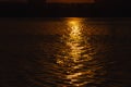 Beautiful sunset over the river. A duck in the solar path on the surface of the water. Reflection of the setting sun