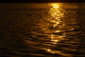 Beautiful sunset over the river. The solar path on the surface of the water. Reflection of the setting sun