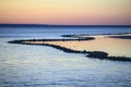 Beautiful sunset over the sea on a frosty weather. Colorful sky with clouds reflected in the water Royalty Free Stock Photo