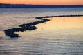 Beautiful sunset over the sea on a frosty weather. Colorful sky with clouds reflected in the water Royalty Free Stock Photo