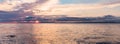 Beautiful sunset over sea with reflection in water, majestic clouds in the sky. BANNER, LONG FORMAT Royalty Free Stock Photo