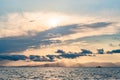 Beautiful sunset over sea with reflection in water, majestic clouds in the sky Royalty Free Stock Photo