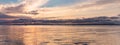 Beautiful sunset over sea with reflection in water, majestic clouds in the sky. BANNER, LONG FORMAT Royalty Free Stock Photo