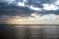 Beautiful sunset over sea with reflection in water, majestic clouds in the sky. Seascape Royalty Free Stock Photo