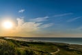 Beautiful sunset over the sea shore. clear summer evening with a little cloud in the sky