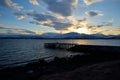 Beautiful sunset over snowy mountain, fjord and pier Royalty Free Stock Photo