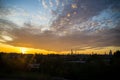Beautiful sunset over a suburb with a city skyline at the horizon Royalty Free Stock Photo