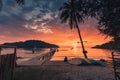 Beautiful sunset over tropical sea and wooden bridge, sightseeing boat and tourist enjoying in Koh Kood beach Royalty Free Stock Photo