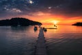 Beautiful sunset over tropical sea and wooden pier, sightseeing boat and tourist enjoying in Koh Kood Island Royalty Free Stock Photo