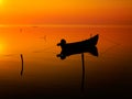 Beautiful sunset over water and silhouette fishing boat Royalty Free Stock Photo