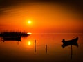 Beautiful sunset over water and silhouette fishing boat Royalty Free Stock Photo