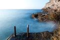 Beautiful sunset over wavy stormy Black sea rocky coastline in Crimea on summer day Royalty Free Stock Photo