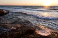 Beautiful sunset over wavy stormy Black sea rocky coastline in Crimea on summer day Royalty Free Stock Photo