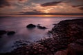 Beautiful sunset picture about sea horizon, and unique volcanic rock formations at Giants Causeway, Norht Ireland