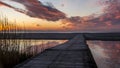 Beautiful sunset. golden, orange, blue colors over the sea. sky full of many colors. bridge over a small lake where the sky is Royalty Free Stock Photo