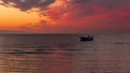 Beautiful sunset. pink, purple, golden, orange, blue colors over the sea. sky full of many colors. Boat in the water Royalty Free Stock Photo