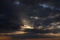 Beautiful sunset, rays make their way through heavy clouds. Royalty Free Stock Photo