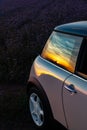 A beautiful sunset is reflected on the car& x27;s door and window Royalty Free Stock Photo