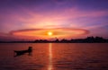 Beautiful sunset with ring clouds, Silhouette landscape of river and local boat Royalty Free Stock Photo