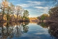 Beautiful sunset on the river in forest with sky reflection Royalty Free Stock Photo