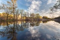 Beautiful sunset on the river in forest with sky reflection Royalty Free Stock Photo