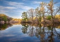 Beautiful sunset on the river in forest with sky reflection Royalty Free Stock Photo