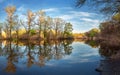 Beautiful sunset on the river in forest with sky reflection Royalty Free Stock Photo