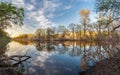 Beautiful sunset on the river in forest with sky reflection Royalty Free Stock Photo