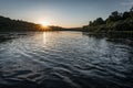 Beautiful sunset on the river, the sun sets over the horizon