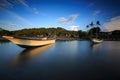 Beautiful sunset scene with fisherman boat and wooden Royalty Free Stock Photo