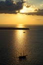 Beautiful sunset scenic ocean view in vast Aegean sea with sailing ship silhouette, abstract cloud and light reflection Royalty Free Stock Photo