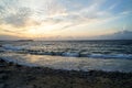 Beautiful sunset scenic wavy seaview and natural rock beach with beautiful shades of soft orange and blue sky and abstract cloud Royalty Free Stock Photo